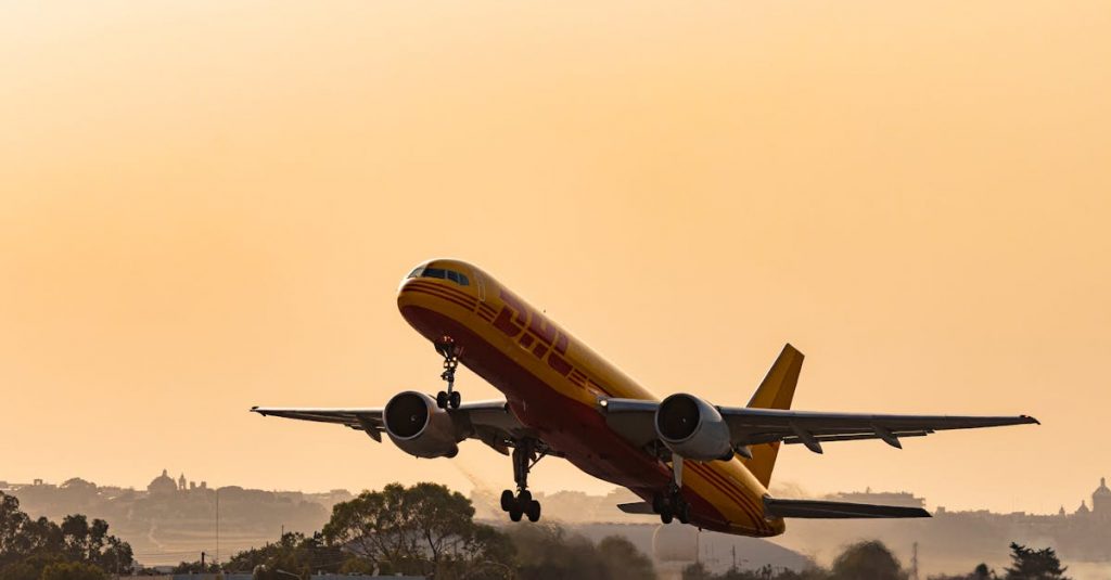 A DHL cargo plane takes off against a golden sunset sky, showcasing aviation in action.